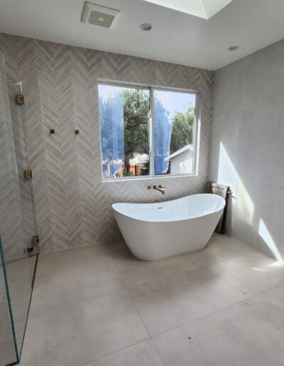 A bathroom with a large tub and a skylight.